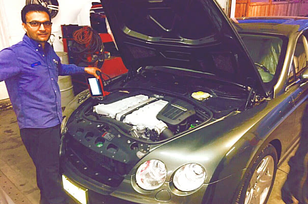 Hood up on a Bentley, scan tool in hand
