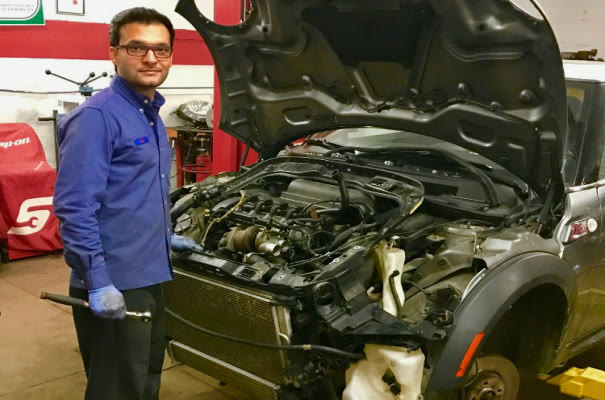 A car with its front end apart and the radiator out